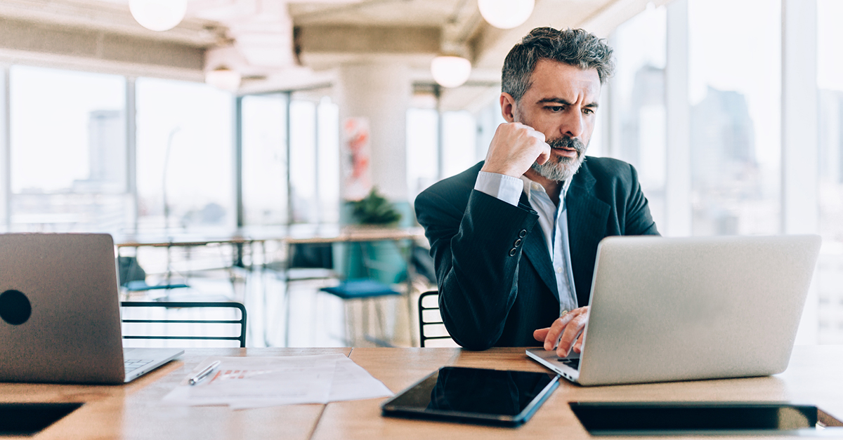 A businessman sitting at a computer