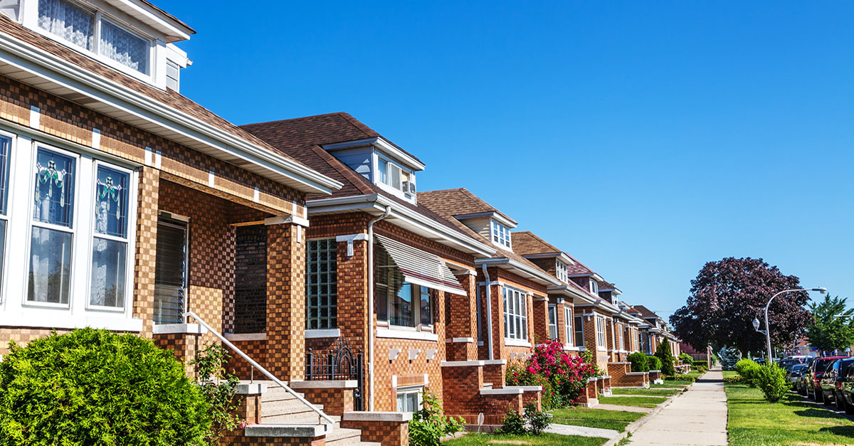 A row of brick homes on a spring day